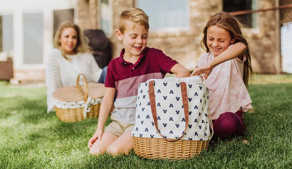 Two children unpacking the Mickey Mouse Coronado Picnic Tote