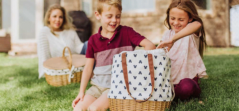 Two children unpacking the Mickey Mouse Coronado Picnic Tote